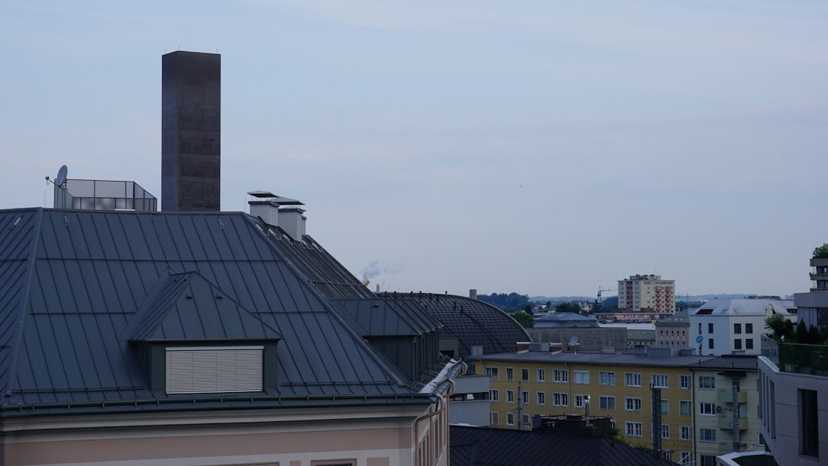 Rooftops of buildings under a cloudy sky